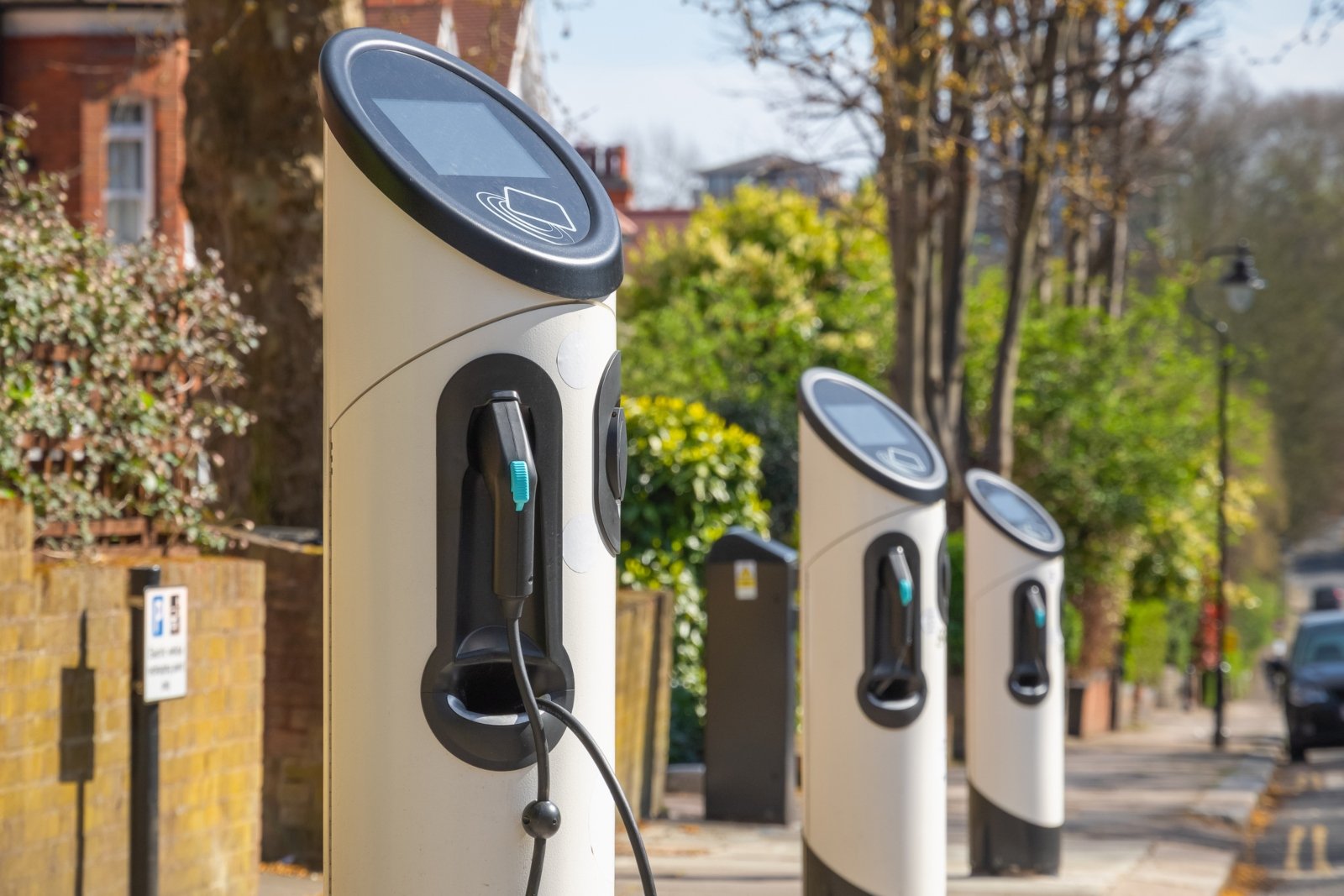 an image showing three ev charge points on a street in the UK