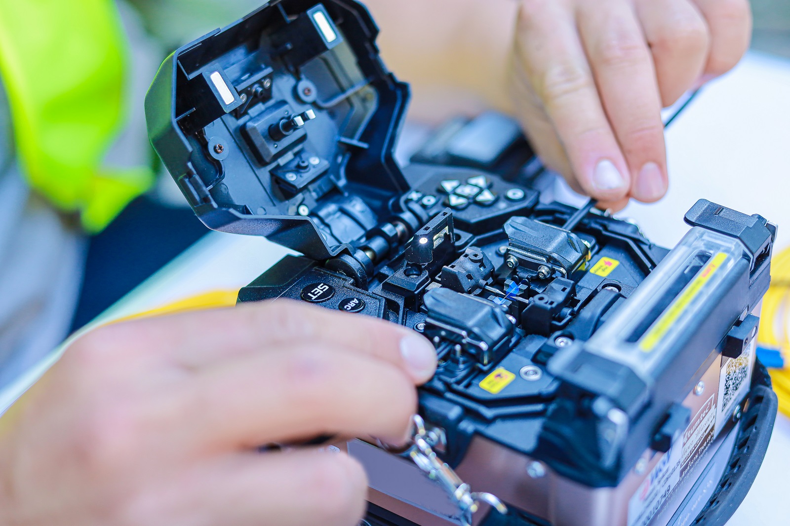 image showing a person fixing fibre cable in a box