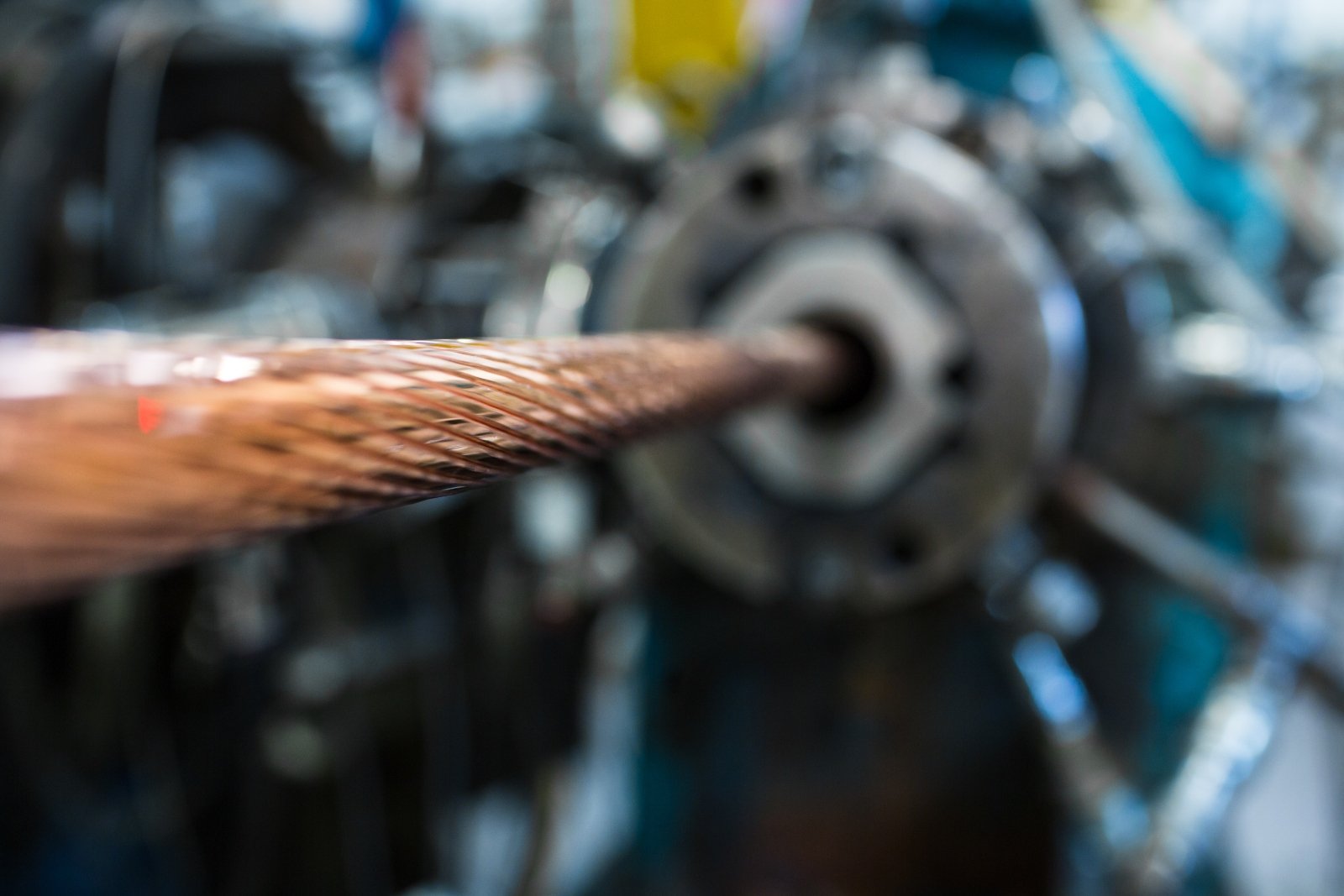 An image showing copper wire being stranded through an industrial machine.