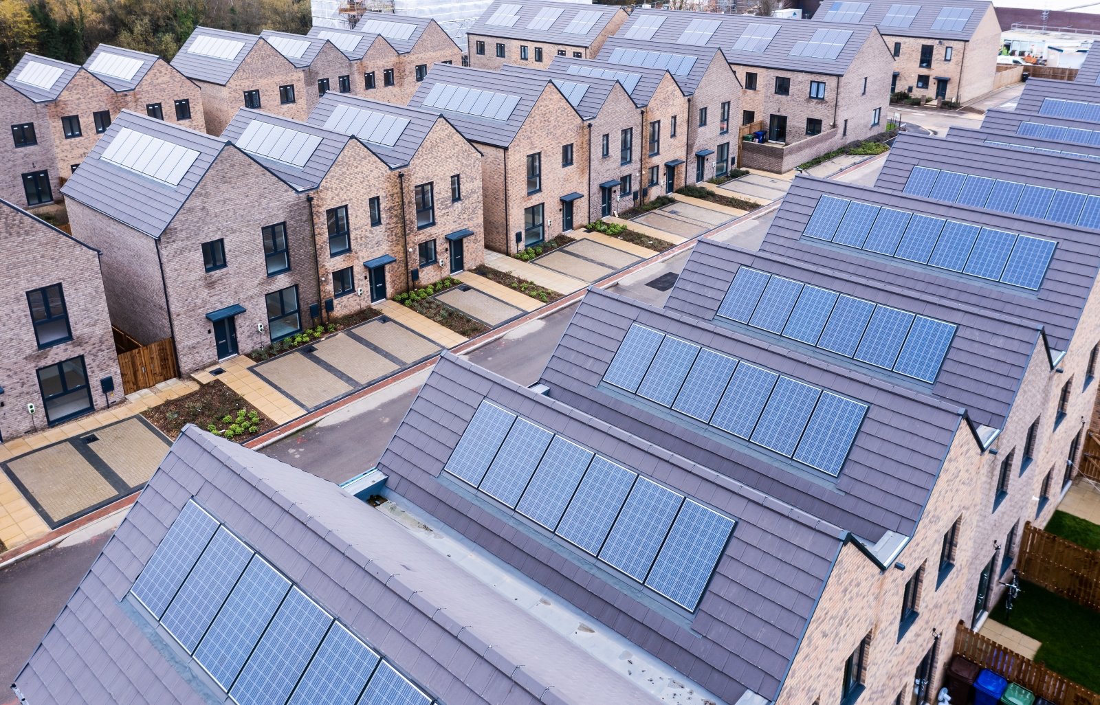 an image showing solar panels on the roofs of UK new build homes