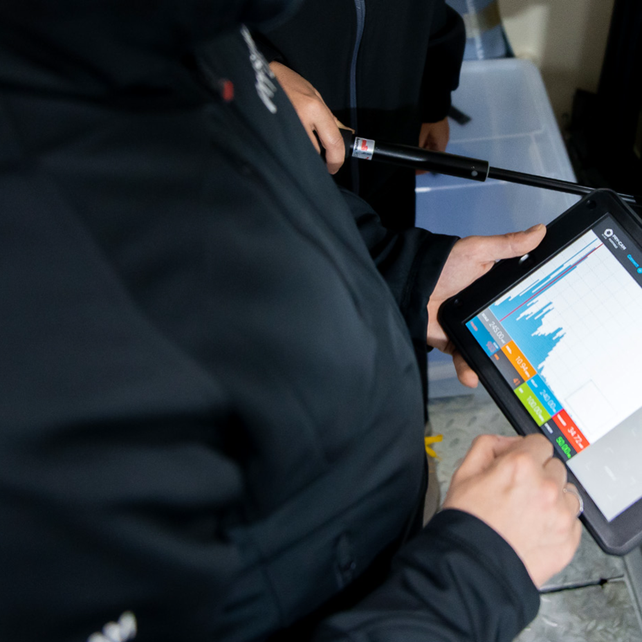 Close up of a person using a tablet style device displaying information from prysmian's Pry-cam