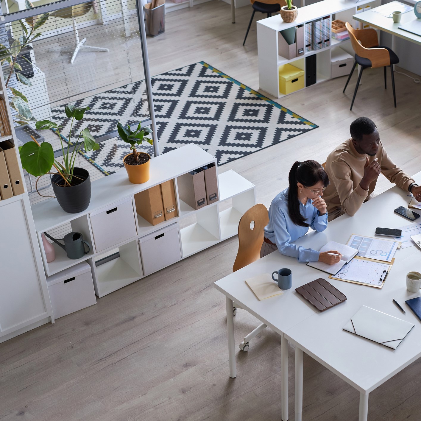 Wide angle of business team working together at meeting table in office stock photo