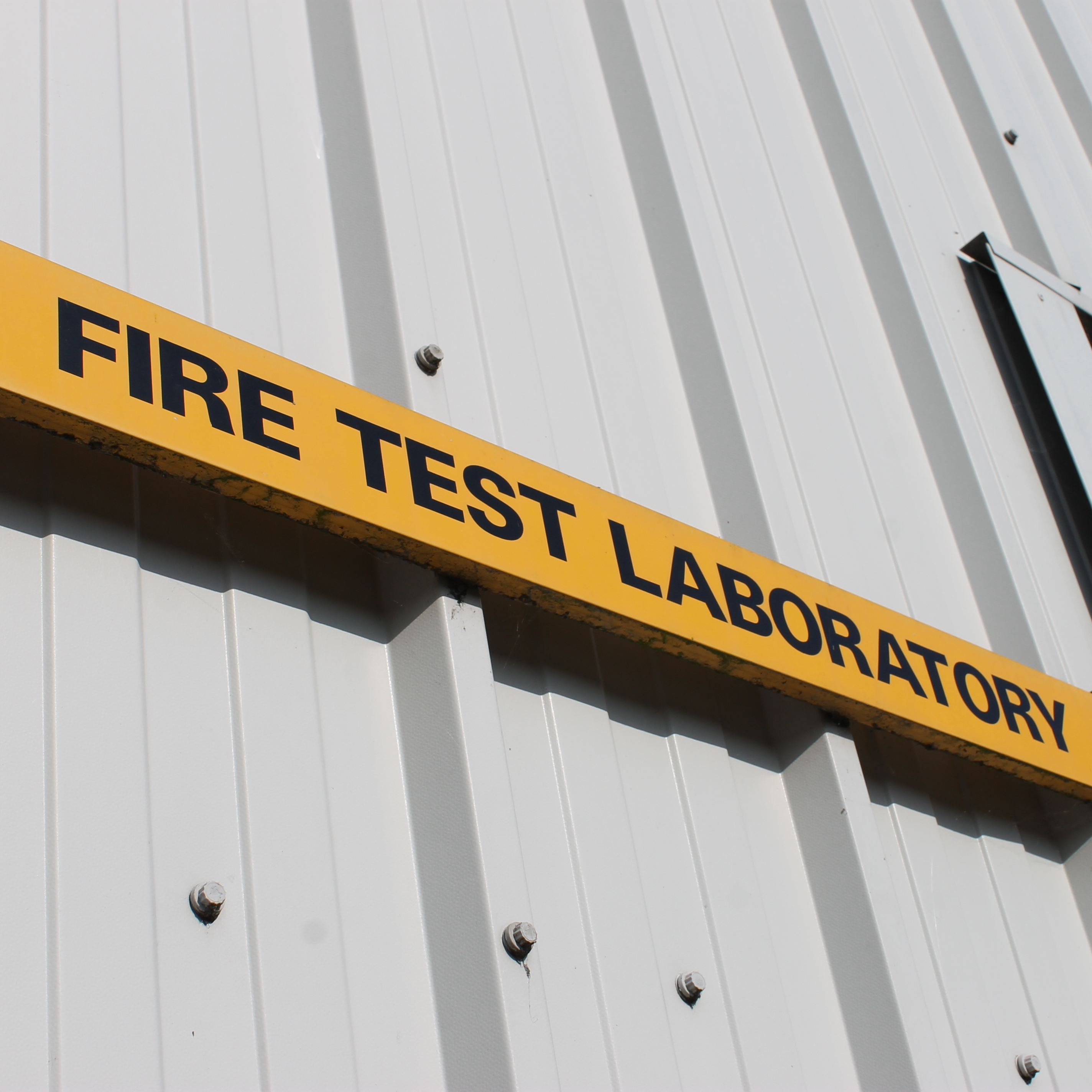 Yellow sign that reads fire test laboratory