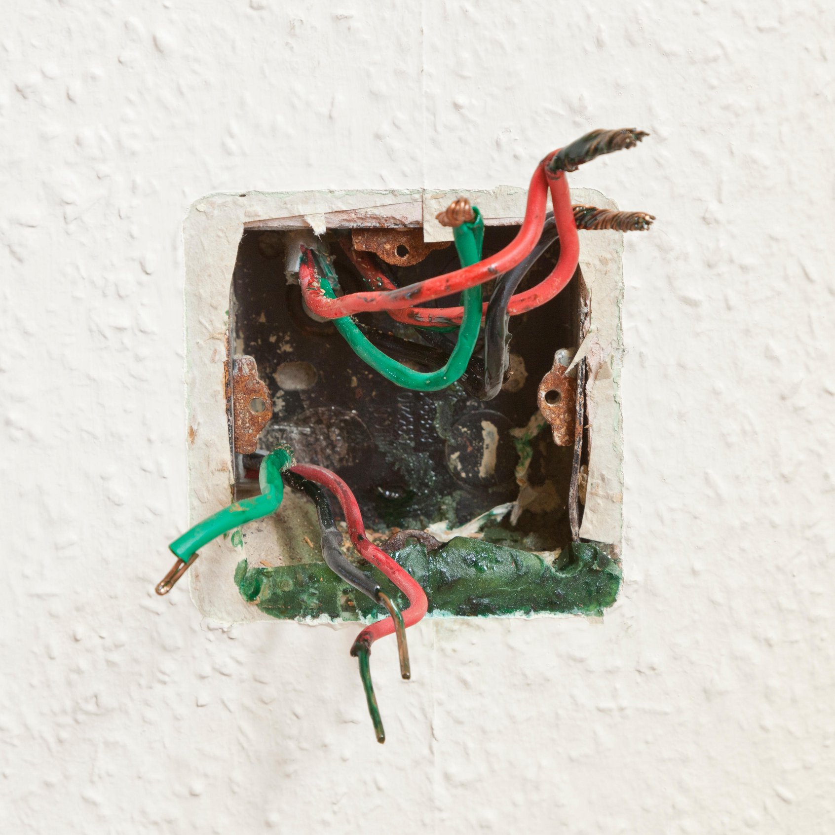 Electrical wiring with the socket removed showing a green disharge which is know an Green Goo, or sometimes refered to Cable Cancer.
