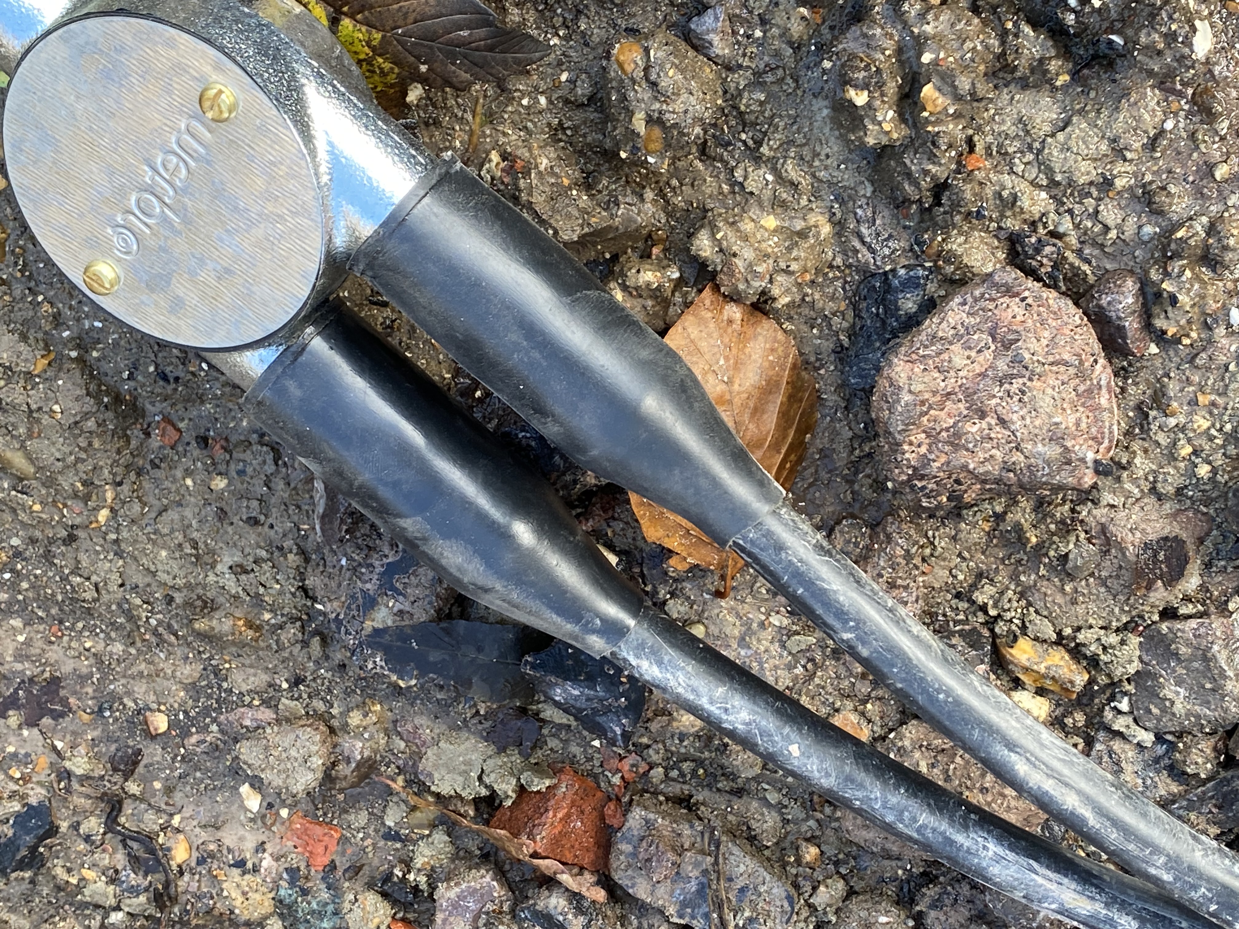 An image of a cable laying on the ground outside