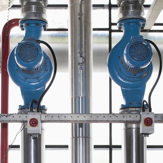 close up shot of 2 blue pumps in a warehouse
