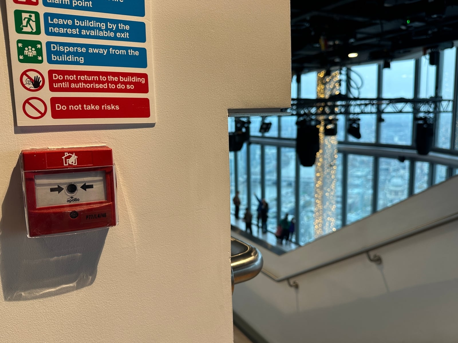 a close up of a fire alarm on a wall in a high-rise building