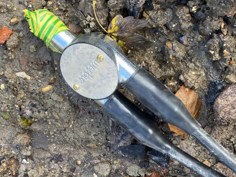 An image showing an armoured cable laying on the ground