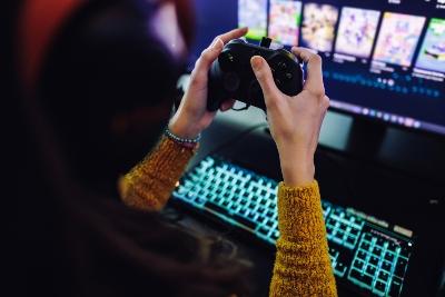 A young woman playing on a games console
