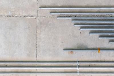 steel tubes screwed into a concrete wall. 