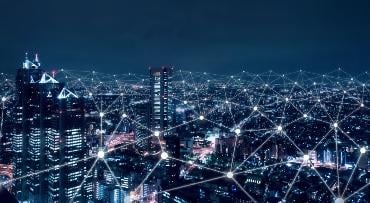 image showing abstract fibre optic lines over a city