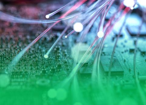 abstract image of fibre stands against a circuit board background.