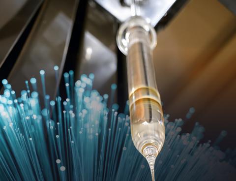 image showing glass tube with fibre strands in the background